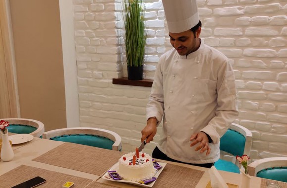 cutting birthday cake by our Kitchen Staff